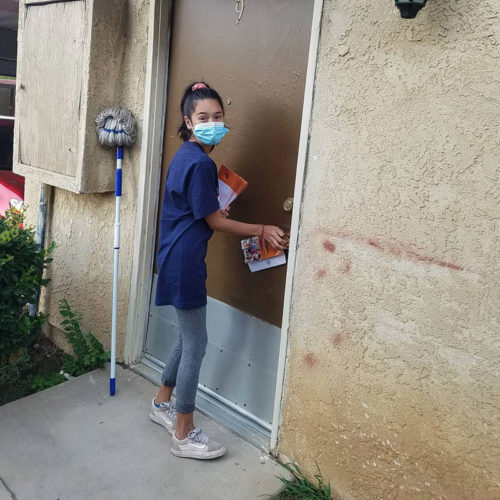 Female volunteer putting sign on door